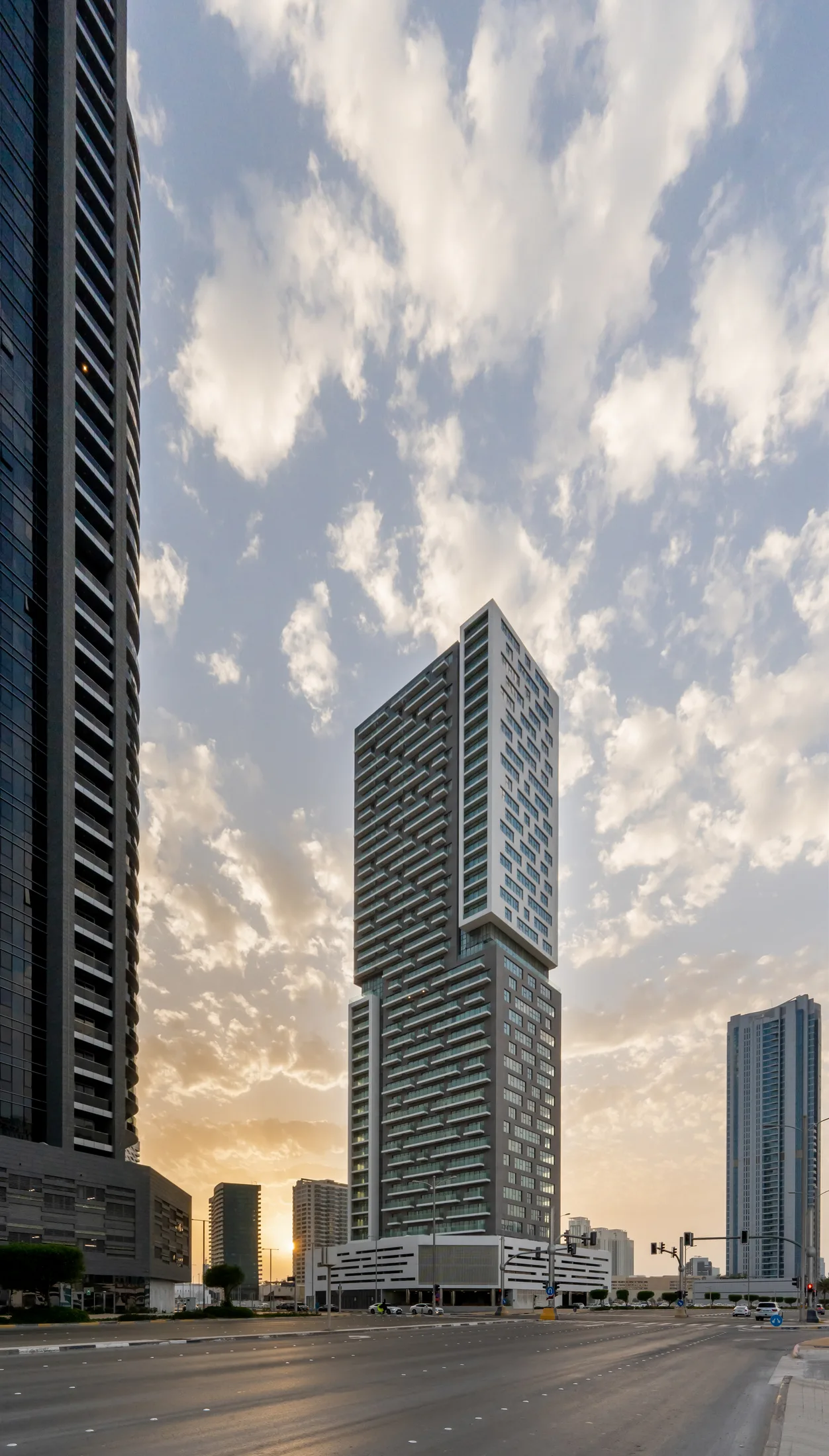 An Abu Dhabi residential tower against high cloud, photographed for Q Holding