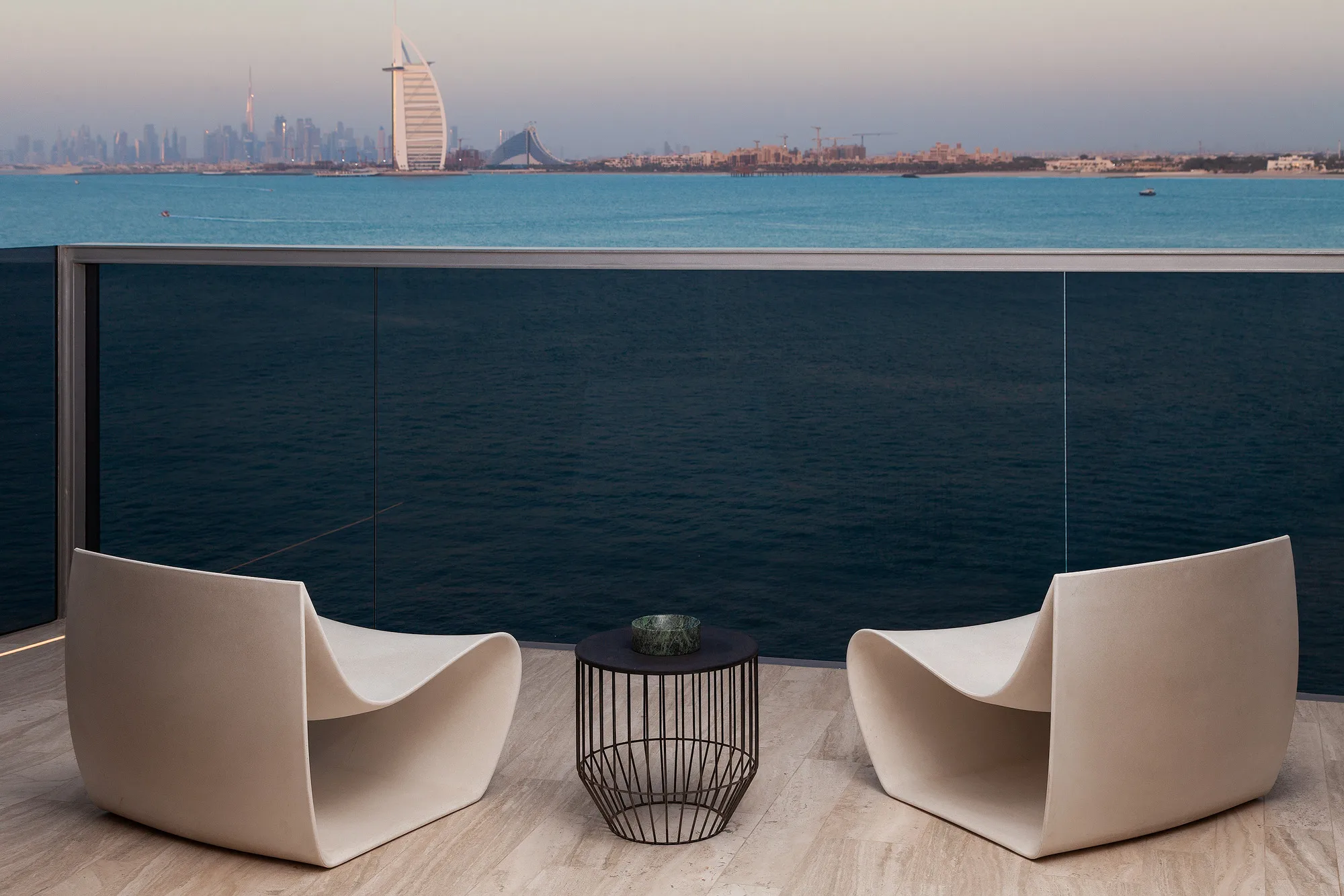 Muraba Residence on the Palm Jumeirah, Dubai, looking across the water to the Burj Al Arab and the city skyline at dusk
