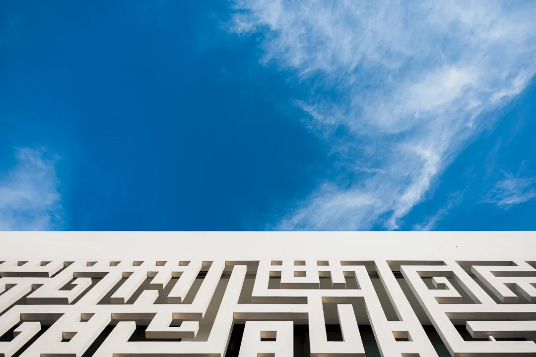 The Kufic inscription on the Diwani House facade, Sharjah, read against open sky