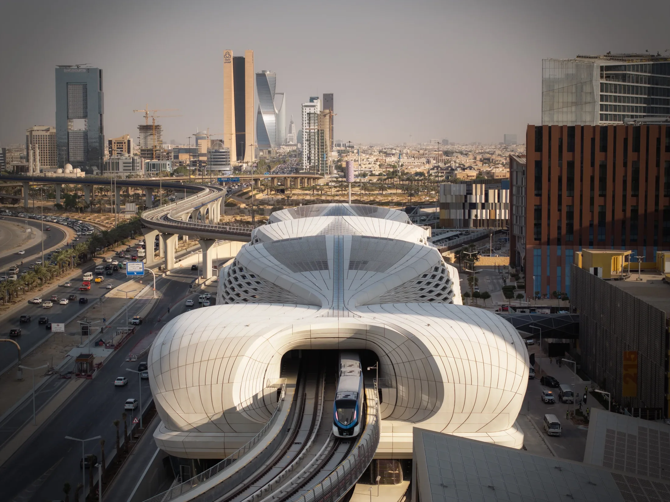 The KAFD Metro Station by Zaha Hadid Architects, with the Riyadh skyline behind